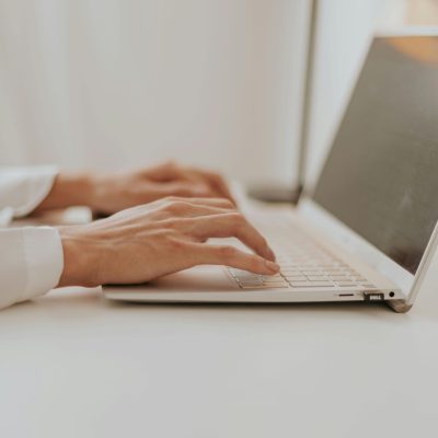 Hands typing on computer